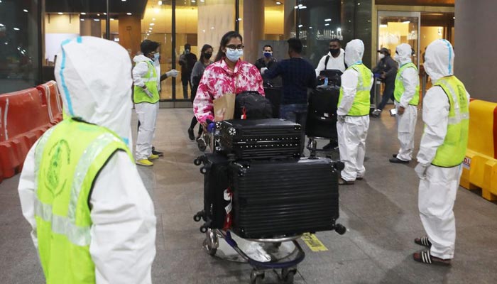 Passengers wearing protective face masks leave upon arrival at Chhatrapati Shivaji Maharaj International Airport after India cancelled all flights from the UK over fears of a new strain of the coronavirus disease (COVID-19), in Mumbai, India, December 22, 2020. — Reuters/File