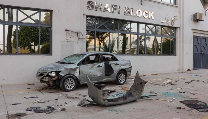 The charred remains of a damaged vehicle is kept near the premises of a factory in Sialkot on December 3, 2021, after police confirmed that a Sri Lankan factory manager was beaten to death and set ablaze by mob, in an incident local media reported was linked to alleged blasphemy. — AFP