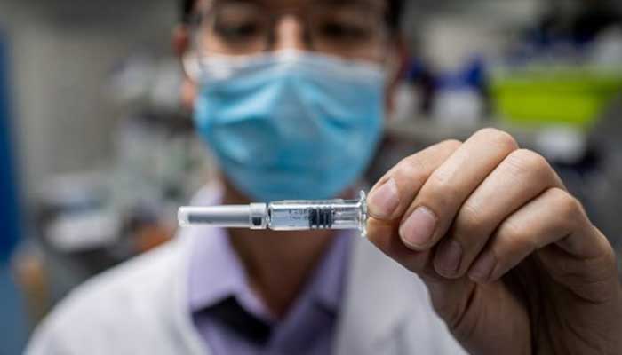 In this picture taken on April 29, an engineer shows an experimental vaccine for the COVID-19 coronavirus that was tested at the Quality Control Laboratory at the Sinovac Biotech facilities in Beijing. — AFP