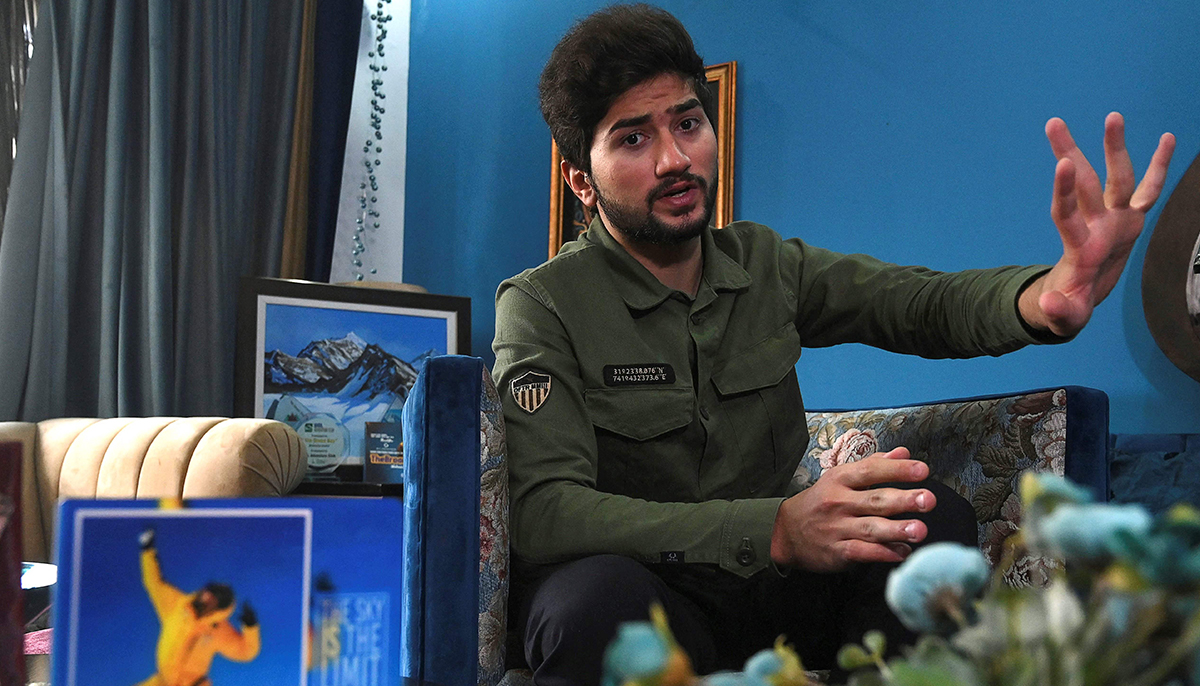 This picture taken on November 16, 2021 shows Pakistani mountaineer Shehroze Kashif speaking during an interview with AFP at his home in Lahore. — AFP