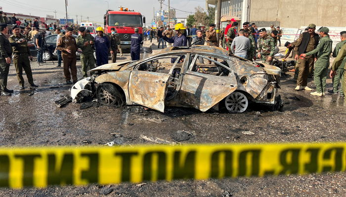 Iraqi security forces inspect the site of an explosion in Basra, Iraq December 7, 2021. — Reuters/Mohammed Aty