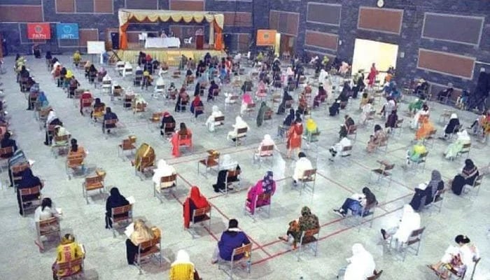 Students taking an exam in an examination hall. —— APP/File