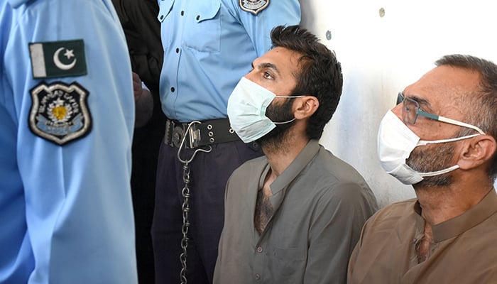 Zahir Jaffer, his father Zakir Jaffer, and six other suspects wait outside the court of Sessions Judge Muhammad Atta Rabbani for a hearing at F-8 Kacheri in Islamabad on September 23, 2021. — Online/File