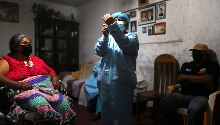 A healthcare worker administers a dose of the Pfizer-BioNTech coronavirus disease (COVID-19) vaccine to a woman during an initiative to vaccinate people over 12 years old, in Lima, Peru December 6, 2021. — Reuters/File