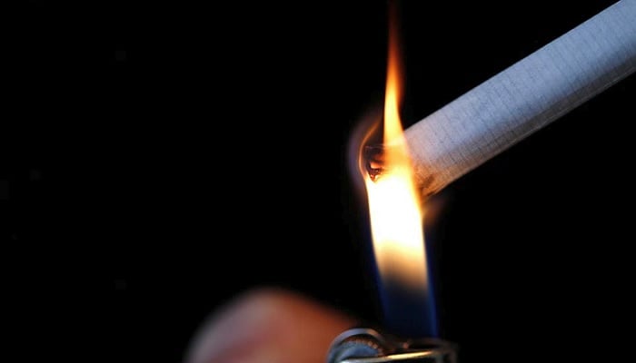 A woman lights a cigarette in this illustration picture. Photo: Reuters