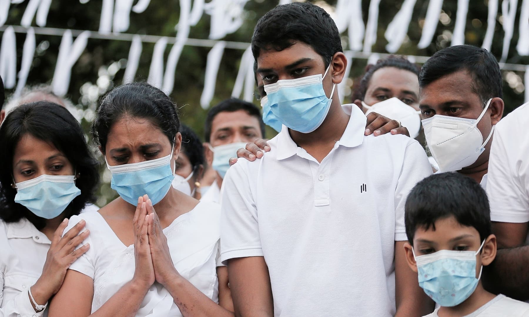 Wife and sons of Priyantha Kumara gathered around coffin. Photo: Reuters