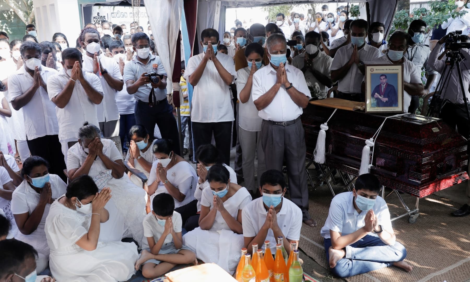 Family and relatives participating in the funeral rituals of Priyantha Kumara. Photo: Reuters