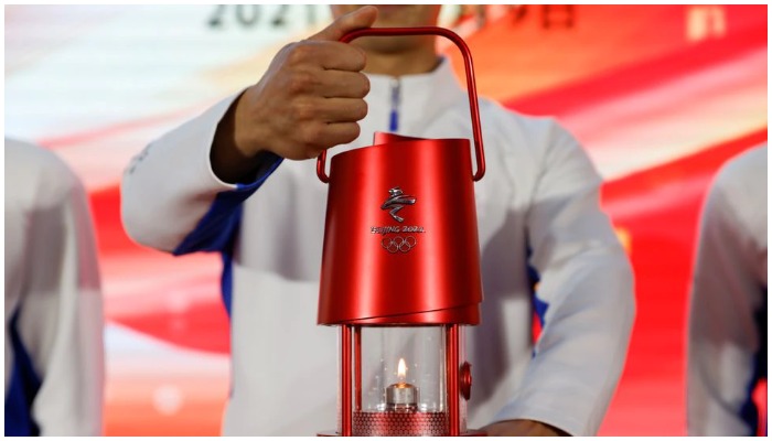 A staff member holds a safety lantern of the Olympic flame for the Beijing 2022 Winter Olympics, during a ceremony of the flame exhibition tour at Beijing University of Posts and Telecommunications in Beijing, China December 9, 2021.— Reuters.