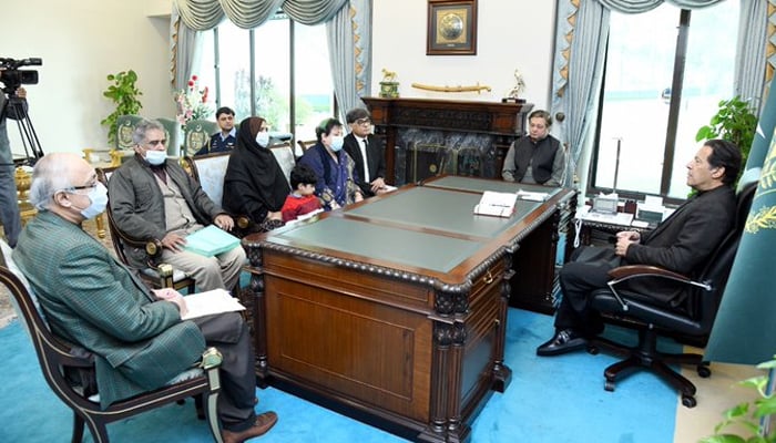 Prime Minister Imran Khan meeting with the parents and son of missing journalist Mudassar Naaru, in Islamabad, on December 9, 2021. — Photo courtesy Shireen Mazari