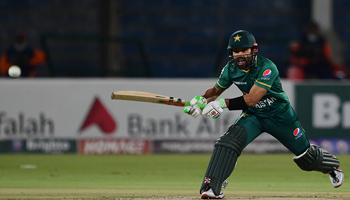 Pakistans Mohammad Rizwan watches the ball after playing a shot during the first Twenty20 international cricket match between Pakistan and West Indies at the National Stadium in Karachi on December 13, 2021. — AFP