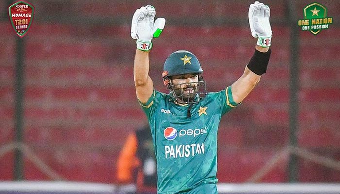 Pakistan wicketkeeper-batter Mohammad Rizwan raises hands for his fans after scoring an impressive half-century against West Indies in the first T20I match at the National Stadium in Karachi. — PCB