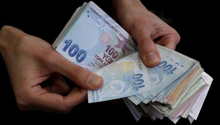 A merchant counts Turkish lira banknotes at the Grand Bazaar in Istanbul, Turkey, March 29, 2019. — Reuters/File