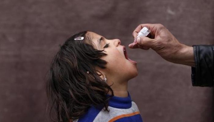 Healthcare worker administering polio drops to a child. — Reuters/File