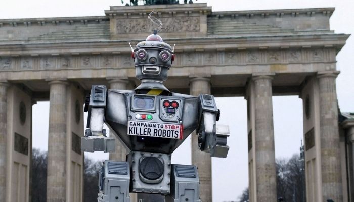 A robot is pictured as an activist from the Campaign to Stop Killer Robots. Photo: Reuters
