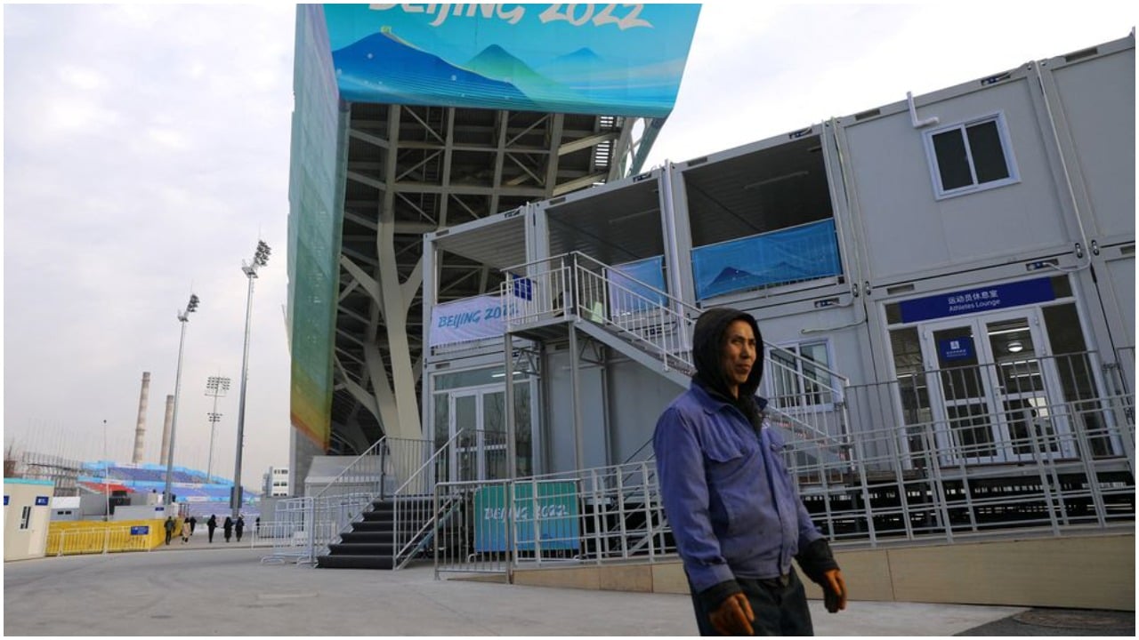 A worker walks under the Big Air Shougang, a competition venue for freestyle skiing and snowboard at the Beijing 2022 Winter Olympics, during an organised media tour, in Beijing, China December 15, 2021. Photo: Reuters
