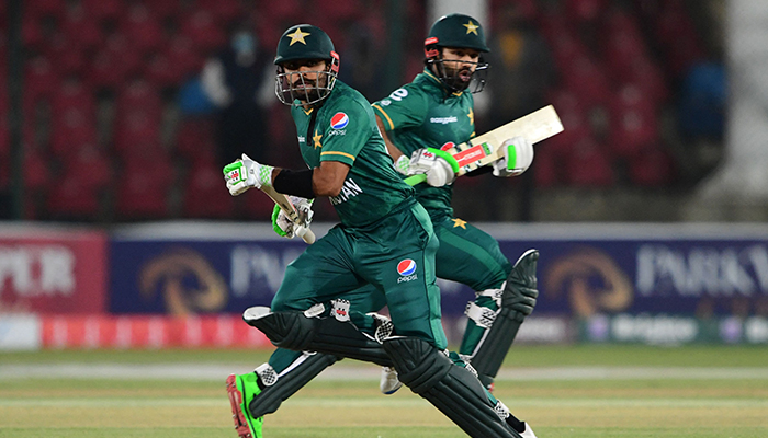 Pakistan´s captain Babar Azam (L) and his teammate Mohammad Rizwan run between the wickets during the third Twenty20 international cricket match between Pakistan and West Indies at the National Stadium in Karachi on December 16, 2021. — AFP