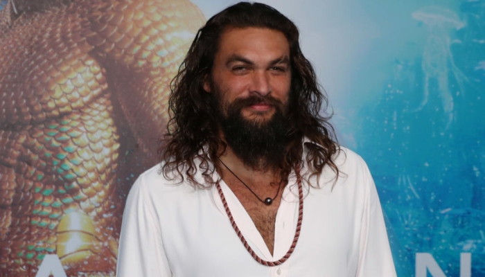 Jason Momoa exhibits toned abs while surfing in Hawaii