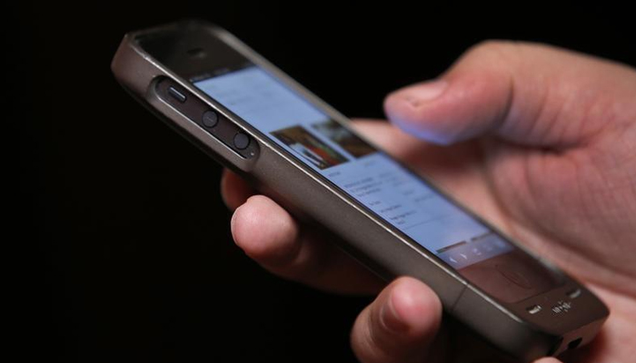 A man uses a smartphone in this picture taken November 6, 2013. — Reuters/File