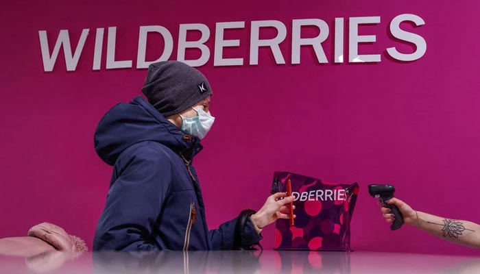 An employee of Wildberries online retailer scans a code on a screen of a smartphone at a pickup point in Moscow, Russia December 16, 2021. — Reuters/File