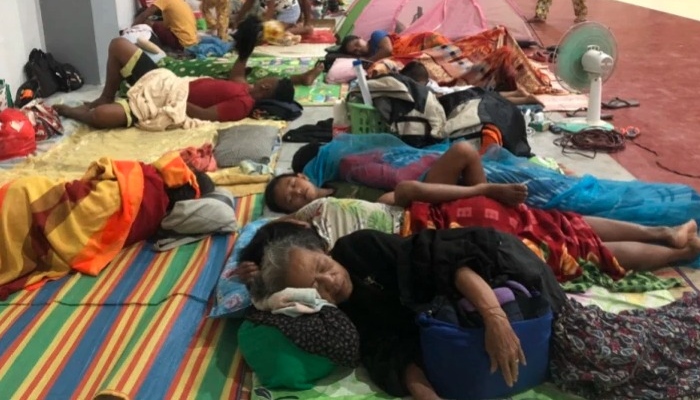 Residents sleep inside a sports complex turned into an evacuation centre in Dapa town, Siargao island ahead of Typhoon Rai’s landfall in the province. Photo: AFP