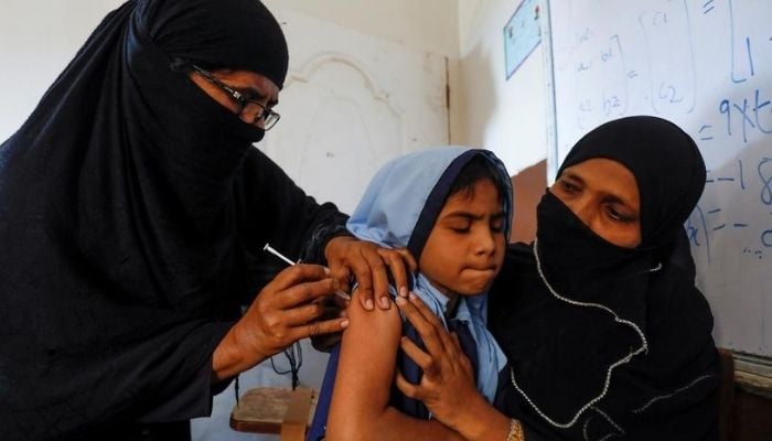 Student being immunised during a free anti-typhoid vaccine campaign at a school in Karachi, Pakistan. — Reuters