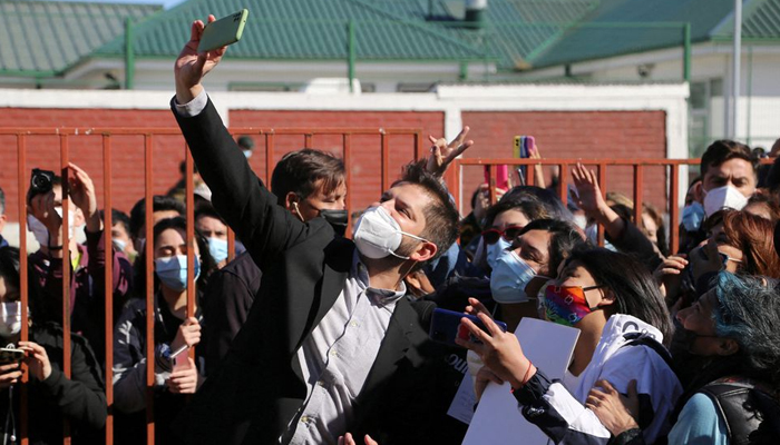 Chiles presidential candidate Gabriel Boric takes a photo with supporters after casting his ballot at a polling station during the presidential election, in Punta Arenas, Chile December 19, 2021. — Reuters/File