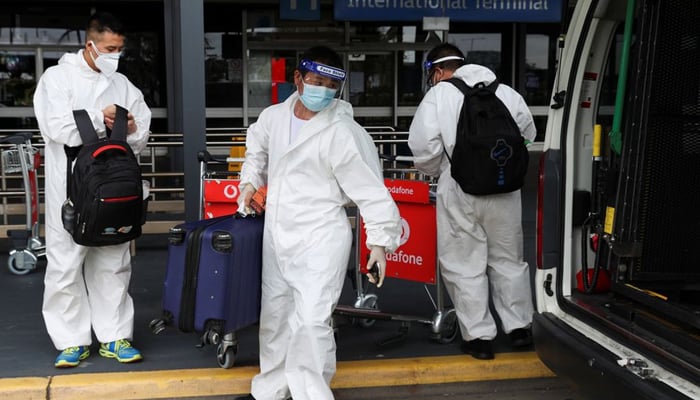 Travellers in personal protective equipment load luggage into a taxi outside the international terminal at Sydney Airport, as countries react to the new coronavirus Omicron variant amid the coronavirus disease (COVID-19) pandemic, in Sydney, Australia, November 29, 2021. — Reuters/File