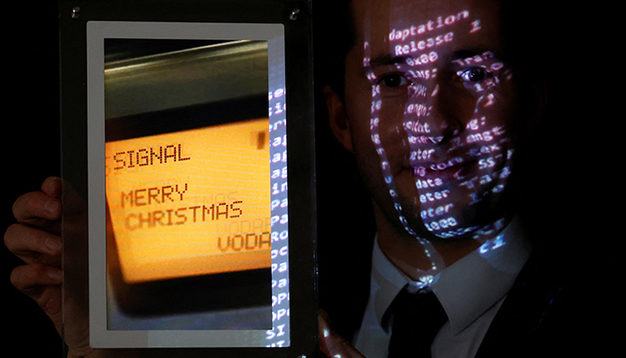 Aguttes auction house head of development Maximilien Aguttes holds a non-fungible token (NFT), replica of the original communication protocol that transmitted the first SMS text message ever sent, before its auction by Britains Vodafone, in Neuilly-sur-Seine, near Paris, France, December 20, 2021. — Reuters