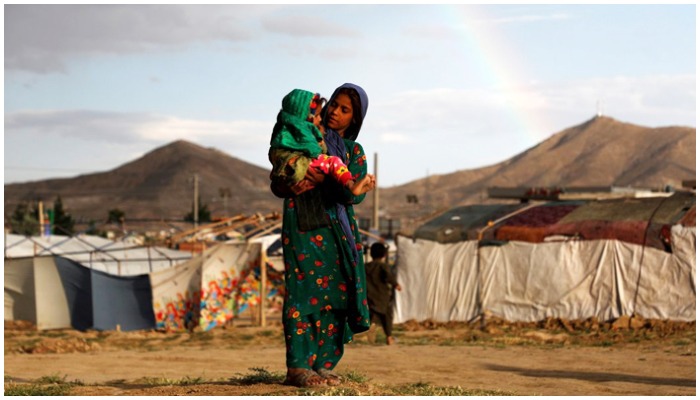 An internally displaced Afghan girl carries a child near their shelter at a refugee camp on the outskirts of Kabul, Afghanistan June 20, 2019. — Reuters/File