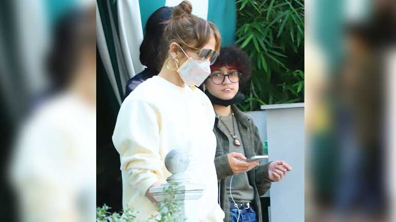 Jennifer Lopez cuts a stylish figure in yellow sweatsuit during lunch date with loved ones