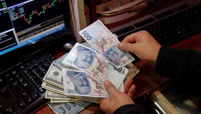 A money changer counts Turkish lira banknotes at a currency exchange office in Ankara, Turkey November 11, 2021. — Reuters/File