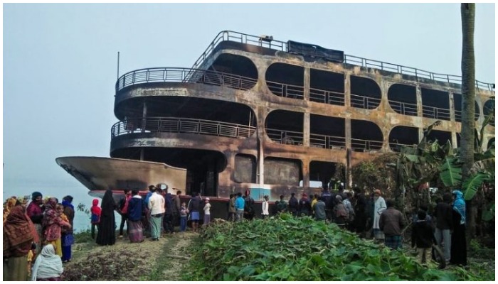 Charred ferry docked at a bank in Bangladesh. Photo: AFP