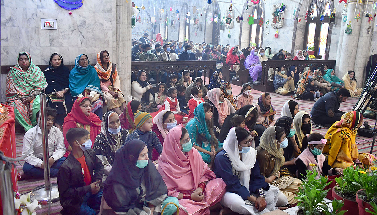 Members of the Christian community can be seen during their religious rituals on the eve of Christmas at St Don Bosco Catholic Church in Lahore on December 25, 2021. — Online