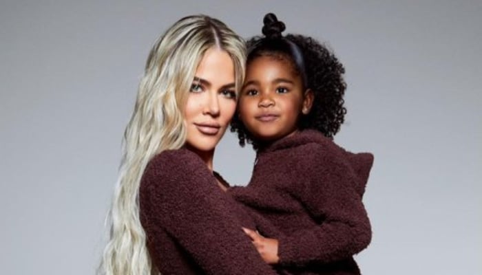 Khloé Kardashian and daughter True twin in glam silver dresses on Christmas eve