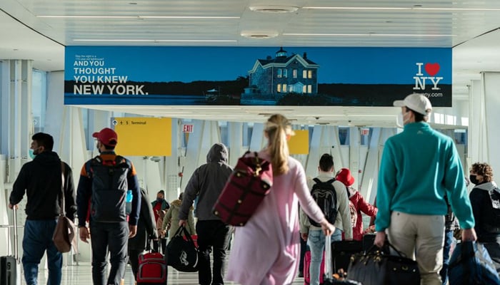 Passengers walk at John F. Kennedy International Airport during the spread of the Omicron coronavirus variant in Queens, New York City, US, December 26, 2021. — Reuters/File