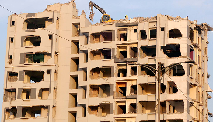 Nasla Towers demolishing works can be seen in progress at Shahrah-e-Faisal road in Karachi, on December 20, 2021. PPI/File