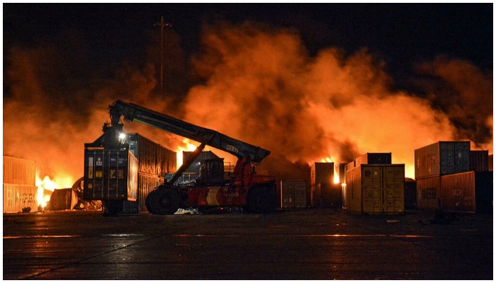 Firefighters battle the huge blaze sparked by an Israeli air strike on the container yard of the Syrian port of Latakia. — AFP