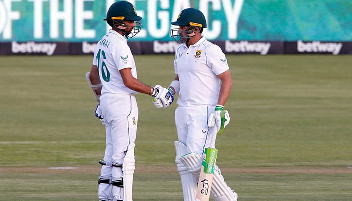 Cricket - First Test - South Africa v India - SuperSport Park Cricket Stadium, Pretoria, South Africa - December 29, 2021 South Africas Dean Elgar celebrates his half century with Keshav Maharaj. — Reuters