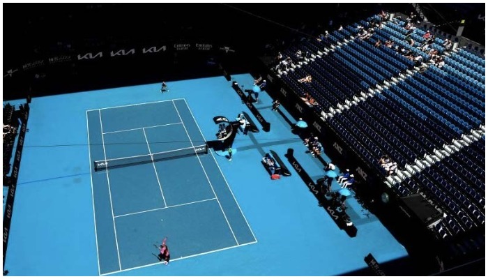Two players practice in a tennis court in Melbourne. — AFP