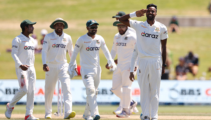 Bangladeshs Ebadot Hossain (R) celebrates the wicket of New Zealands Devon Conway during day four of the first cricket Test match between New Zealand and Bangladesh at the Bay Oval in Mount Maunganui on January 4, 2022. — AFP