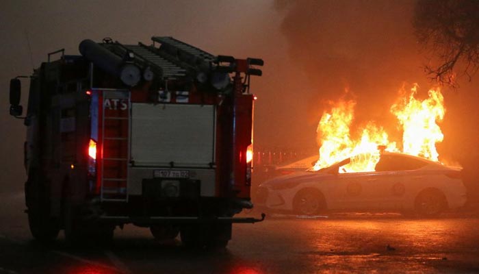 A view shows a burning police car during a protest against LPG cost rise following the Kazakh authorities decision to lift price caps on liquefied petroleum gas in Almaty, Kazakhstan January 5, 2022. — Reuters