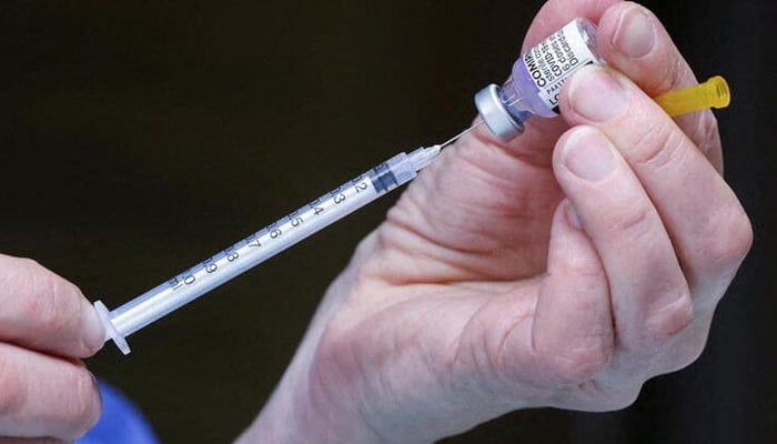 A medical staff prepares a booster dose of Pfizers coronavirus disease (COVID-19) vaccine are seen at a vaccination centre in Brussels, Belgium, January 5, 2022. — Reuters