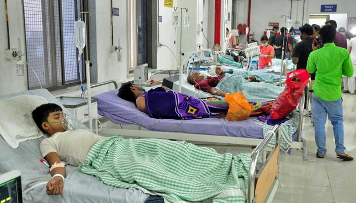Workers of a dyeing and printing mill receive treatment in a hospital after they, according to officials inhaled toxic gas caused by an illegal dump of waste chemicals, in Surat, India, January 6, 2022. — Reuters