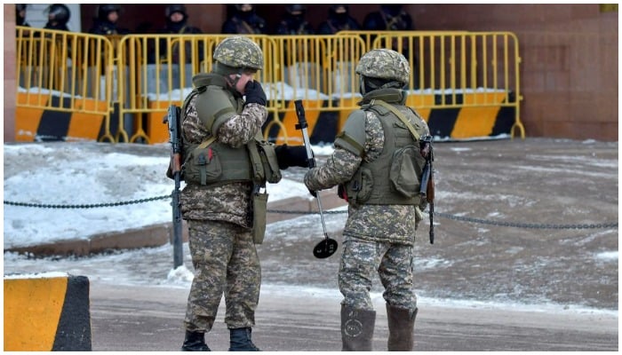 Kazakh law enforcement officers block a street leading to the official presidential residence Akorda after protests against the government, following authorities decision to lift price caps on liquefied petroleum gas, in Nur-Sultan, Kazakhstan, January 6, 2022.—