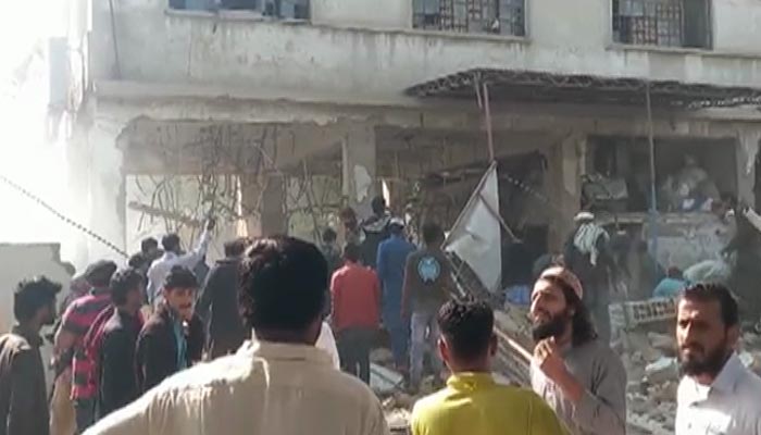 People are seen at the site of the blast in Karachis Shershah area last month. — YouTube screengrab