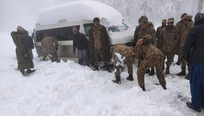 Soldiers clear snow from a road after a heavy snowfall in Murree, Pakistan January 8, 2022. — Reuters