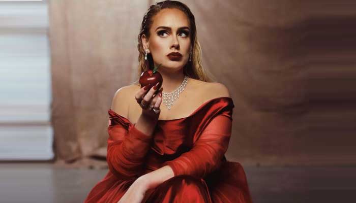 Adele sends temperatures soaring as she rocks hot red gown in new music video Oh My God