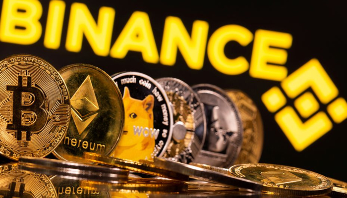 Representations of cryptocurrencies Bitcoin, Ethereum, DogeCoin, Ripple, and Litecoin are seen in front of a displayed Binance logo in this illustration taken, June 28, 2021. — Reuters/File