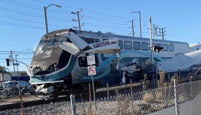 A train hits an aircraft that crashed on railway tracks in Los Angeles, California, U.S. January 9, 2022 in this screen grab from a social media video obtained by Reuters. — Reuters