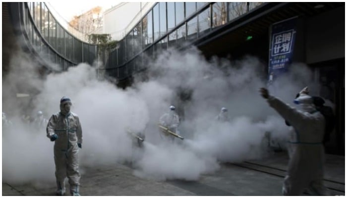 Disinfectant is sprayed outside a shopping mall in Xian. Photo: AFP